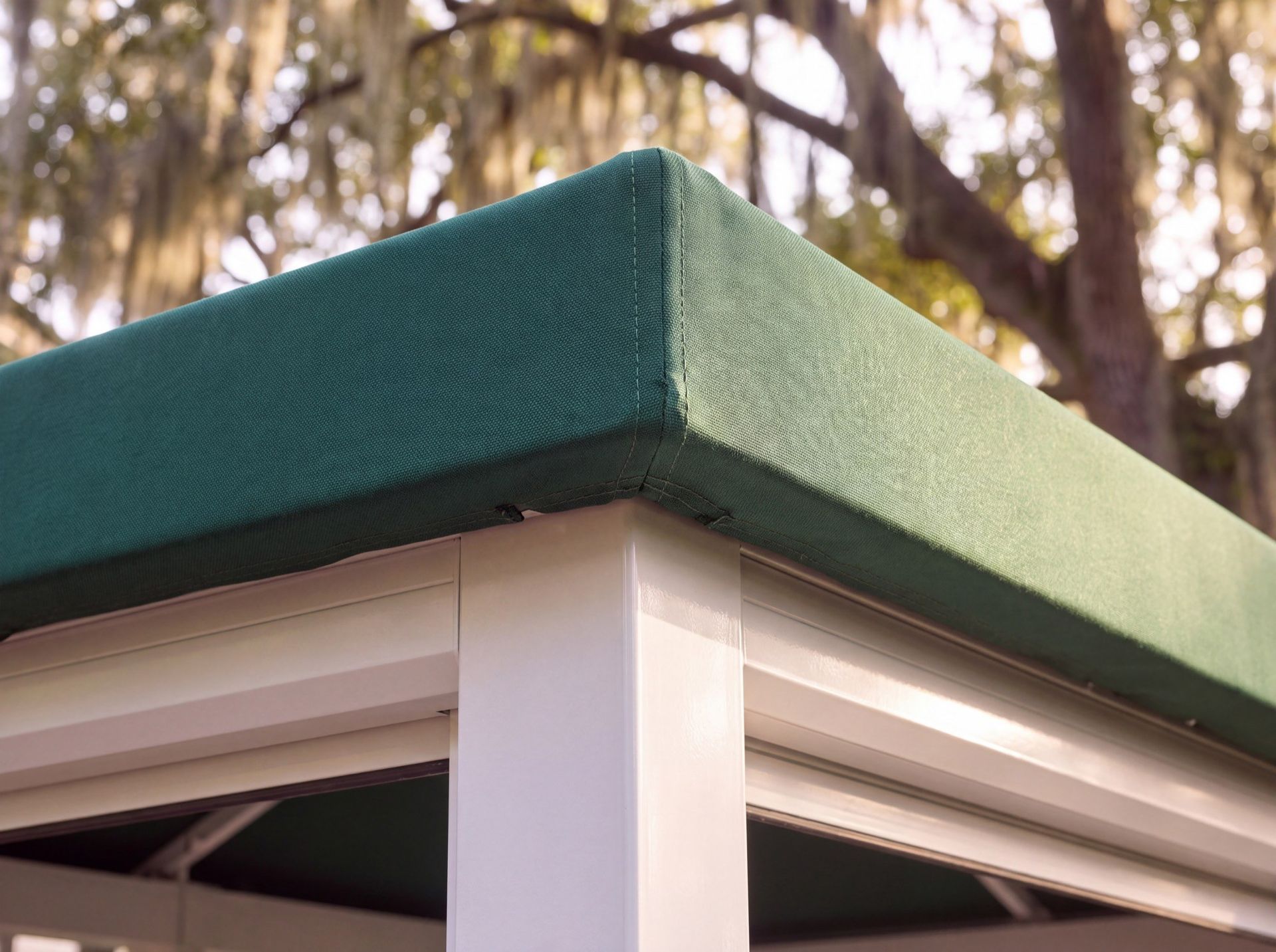 A close view of the sewn canvas top and the frame corner of a cabana