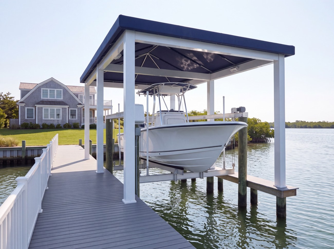 A cabana sheltering a center console boat on a lift over the water