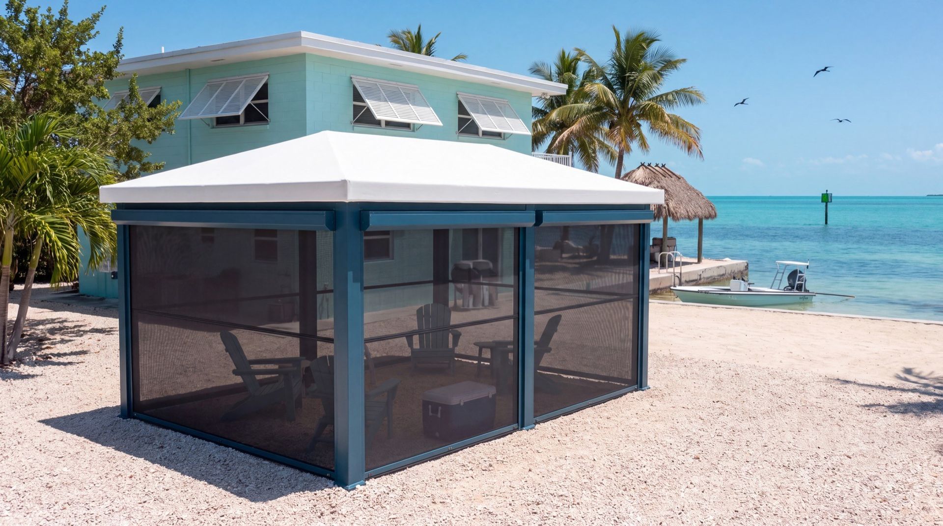 A screened Haven beside a beach house with loungers under it