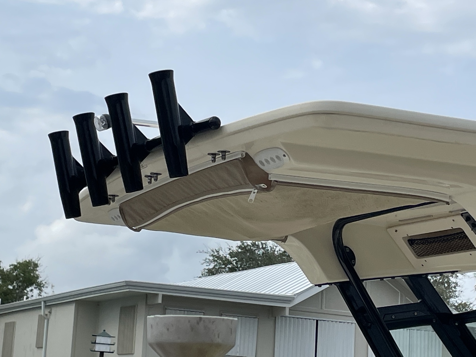 Rod holders installed below a boat top
