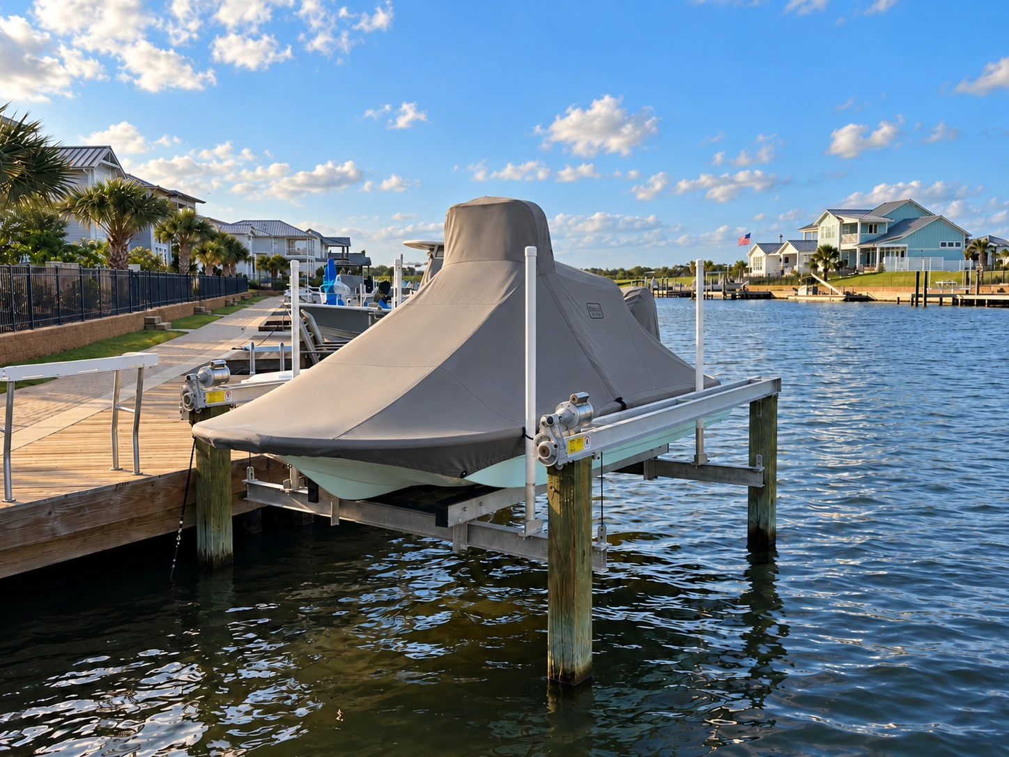 A Shallowsport 18 Sport under a fitted taupe Canvas USA® full boat cover on its waterfront lift