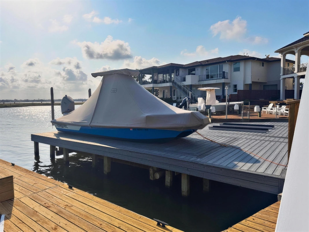 After: the same Haynie 23 Cat under a fitted gray Canvas USA® full boat cover