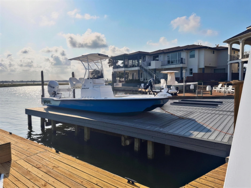 Before: a Haynie 23 Cat bay boat on a dock with no cover