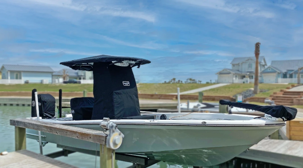 A Blackjack 226 on its lift with fitted black Canvas USA® console, seat and trolling motor covers