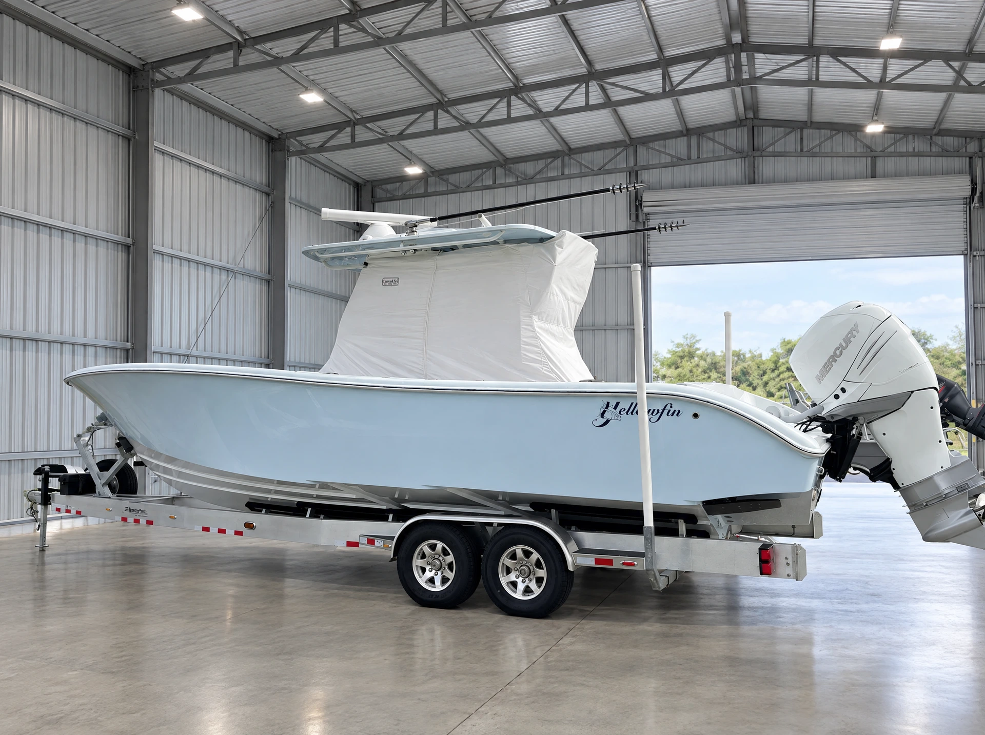 A Yellowfin on its trailer in a boat barn with a fitted white Canvas USA® console cover