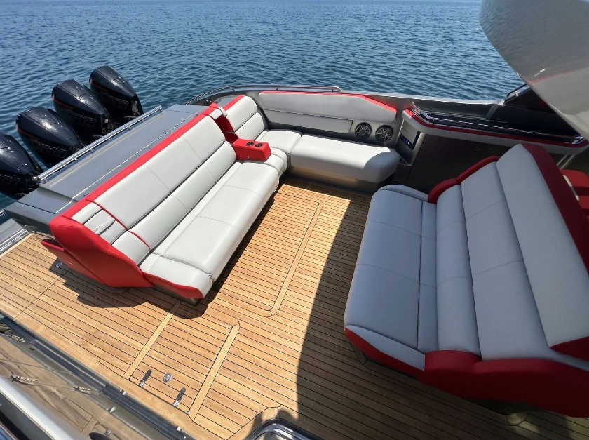 Red and gray Canvas USA® lounge cushions on a teak deck