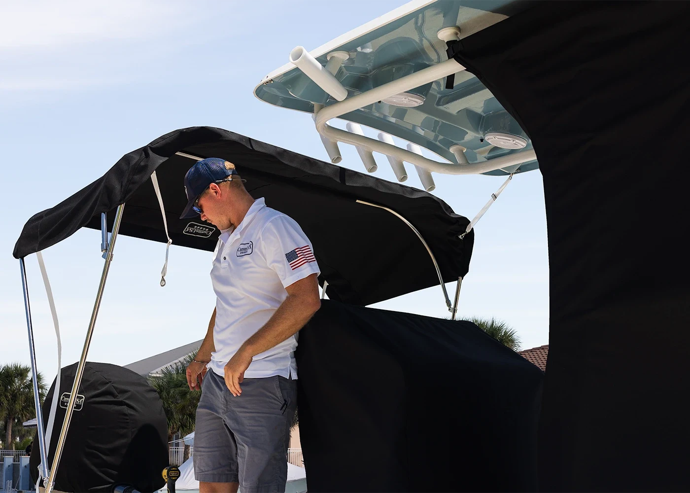 Canvas USA® installer fitting a black T-top enclosure on a Sportsman